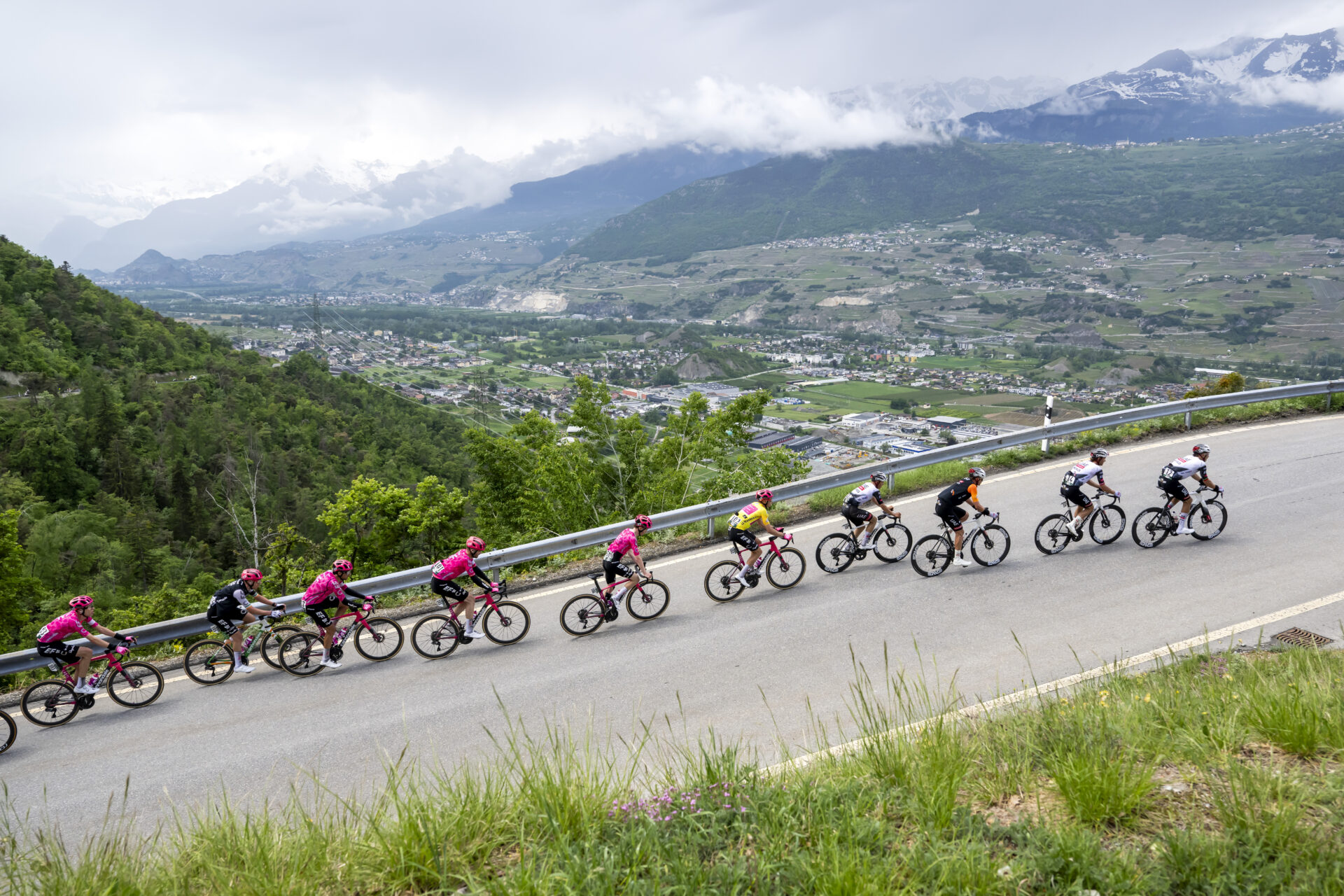 Overall leader yellow jersey Alex Baudin from France of team EF Education-Easypost, and the overall orange points classification jersey Jay Vine from Australia of UAE Team Emirates XRG, 3rd right, climb to Nax, during the fourth stage, a 118,2 km race between Sion and Thyon 2000 at the 78th Tour de Romandie UCI World Tour Cycling race, in Nax, Switzerland, Saturday, May 3, 2025. (KEYSTONE/Jean-Christophe Bott)