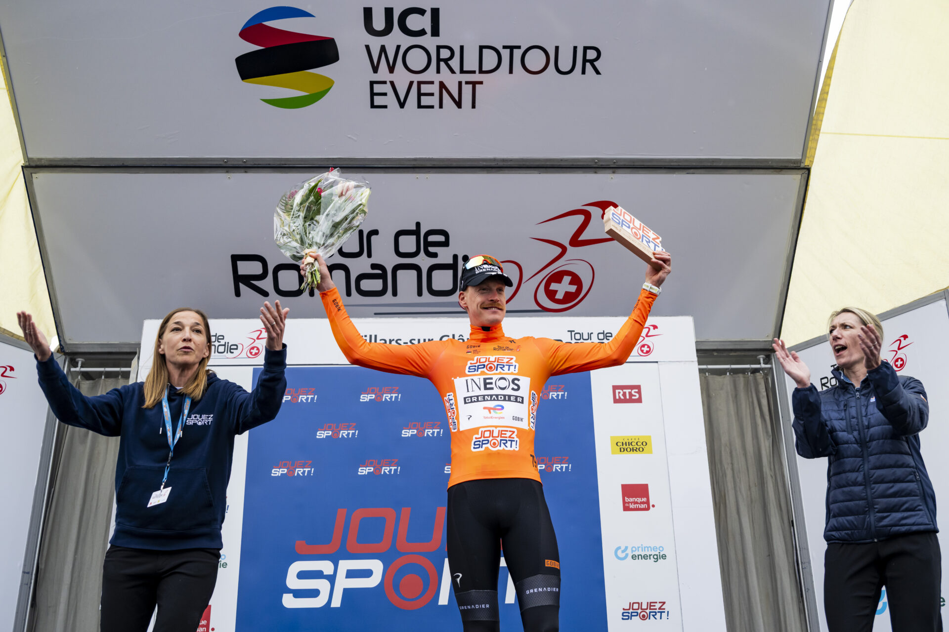 The winner of the stage Dorion Godon from France of team INEOS Grenadiers celebrates on the podium during the prologue, a 3,2 km race against the clock at the 79th Tour de Romandie UCI World Tour Cycling race, in Villars-sur-Glane, Switzerland, Tuesday, April 28, 2026. (KEYSTONE/Jean-Christophe Bott)
