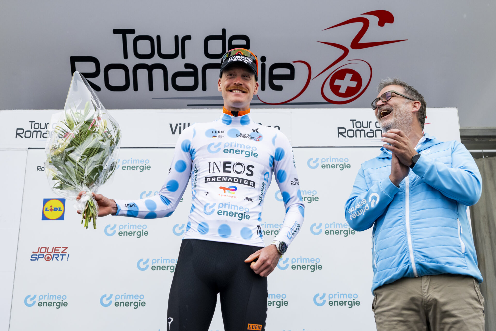 The winner of the stage Dorion Godon from France of team INEOS Grenadiers celebrates on the podium during the prologue, a 3,2 km race against the clock at the 79th Tour de Romandie UCI World Tour Cycling race, in Villars-sur-Glane, Switzerland, Tuesday, April 28, 2026. (KEYSTONE/Jean-Christophe Bott)