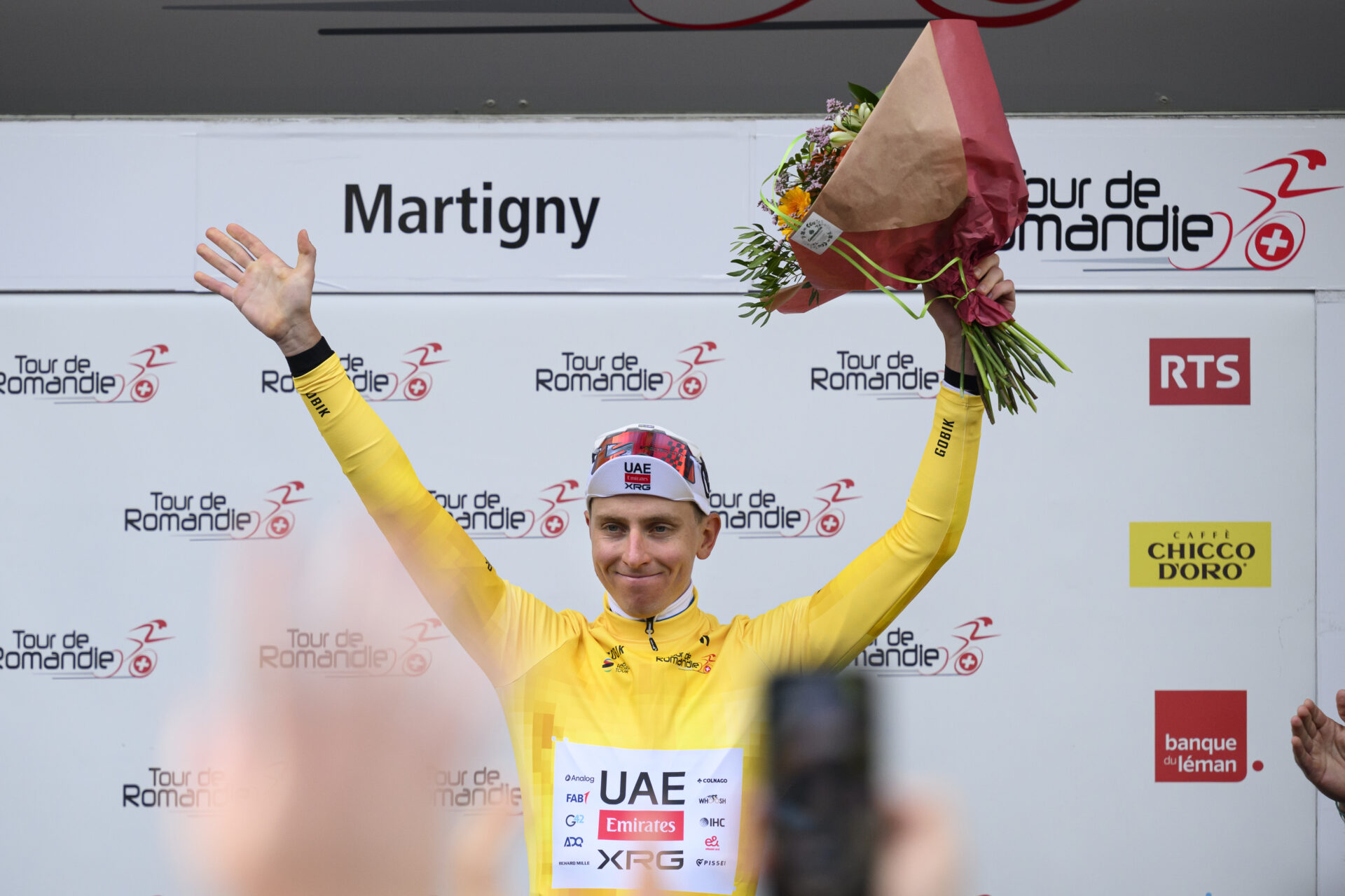 Tadej Pogacar from Slovenia of UAE Team Emirates XRG celebrates on the podium with the yellow jersey after winning the first stage, a 170,6 km race around Martigny at the 79th Tour de Romandie UCI World Tour Cycling race, in Martigny, Switzerland, Wednesday, April 29, 2026. (KEYSTONE/Laurent Gillieron)