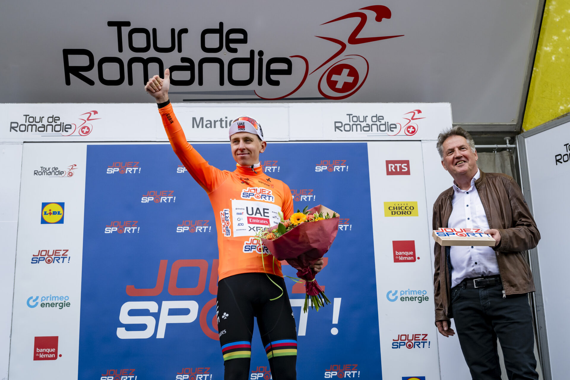 The winner of the stage Tadej Pogacar from Slovenia of UAE Team Emirates XRG celebrates on the podium during the first stage, a 170,6 km race around Martigny at the 79th Tour de Romandie UCI World Tour Cycling race, in Martigny, Switzerland, Wednesday, April 29, 2026. (KEYSTONE/Jean-Christophe Bott)