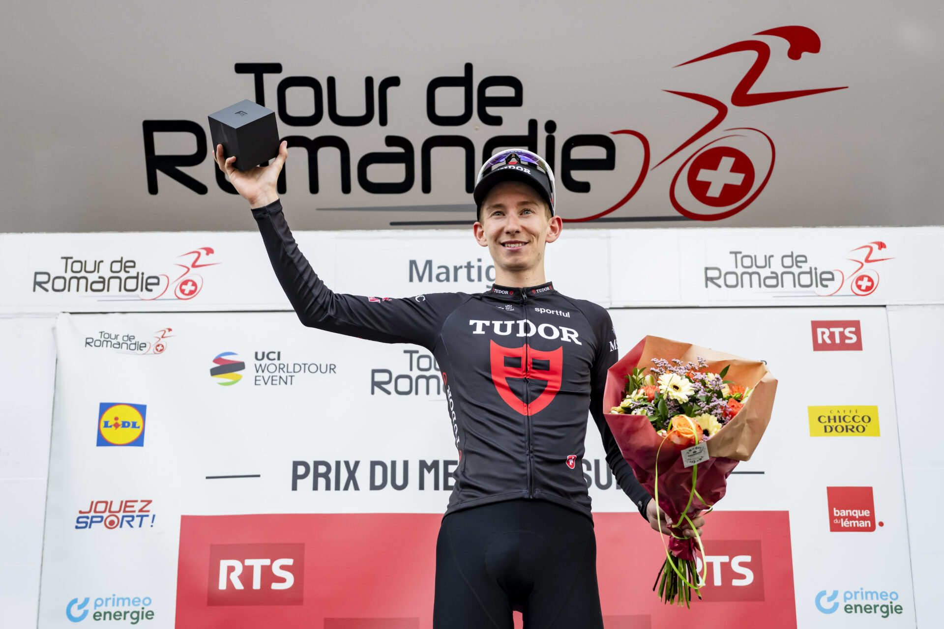 Yannis Voisard from Switzerland of Tudor Pro Cycling Team celebrates on the podium during the first stage, a 170,6 km race around Martigny at the 79th Tour de Romandie UCI World Tour Cycling race, in Martigny, Switzerland, Wednesday, April 29, 2026. (KEYSTONE/Jean-Christophe Bott)