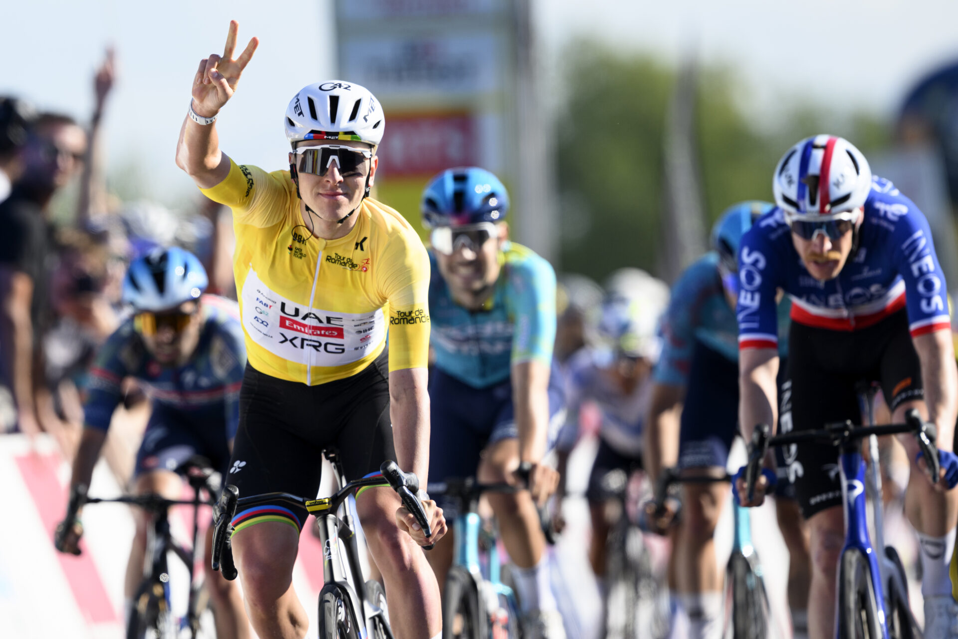 Winner Tadej Pogacar, left, from Slovenia of UAE Team Emirates XRG wins in front of second placed Dorion Godon, third from right, from France of team INEOS Grenadiers after crossing the finish line to win the second stage, a 173,1 km race between Rue and Vucherens at the 79th Tour de Romandie UCI World Tour Cycling race, in Vucherens, Switzerland, Thursday, April 30, 2026. (KEYSTONE/Laurent Gillieron)