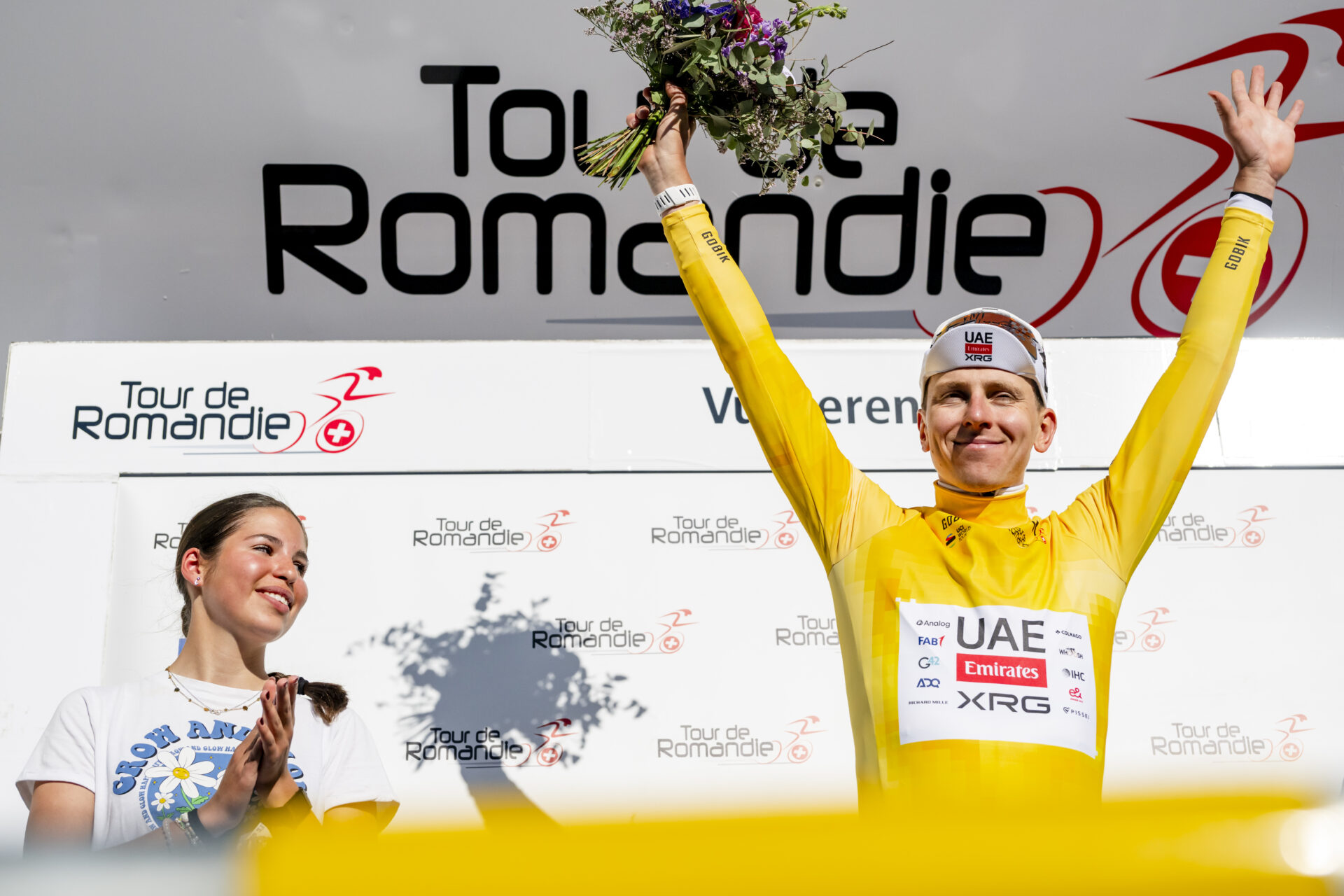 The winner of the stage and overall leader Tadej Pogacar from Slovenia of UAE Team Emirates XRG celebrates on the podium with the yellow jersey during the second stage, a 173,1 km race between Rue and Vucherens at the 79th Tour de Romandie UCI World Tour Cycling race, in Vucherens, Switzerland, Thursday, April 30, 2026. (KEYSTONE/Jean-Christophe Bott)