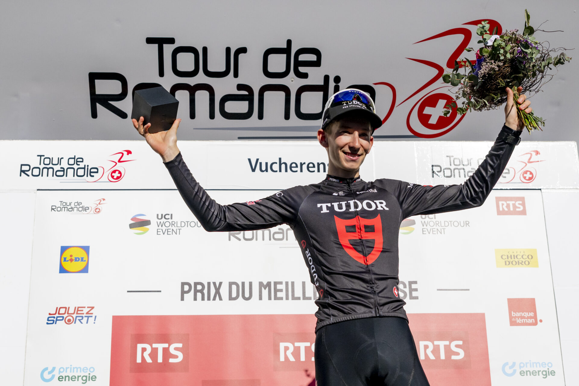 Yannis Voisard from Switzerland of Tudor Pro Cycling Team celebrates on the podium during the second stage, a 173,1 km race between Rue and Vucherens at the 79th Tour de Romandie UCI World Tour Cycling race, in Vucherens, Switzerland, Thursday, April 30, 2026. (KEYSTONE/Jean-Christophe Bott)