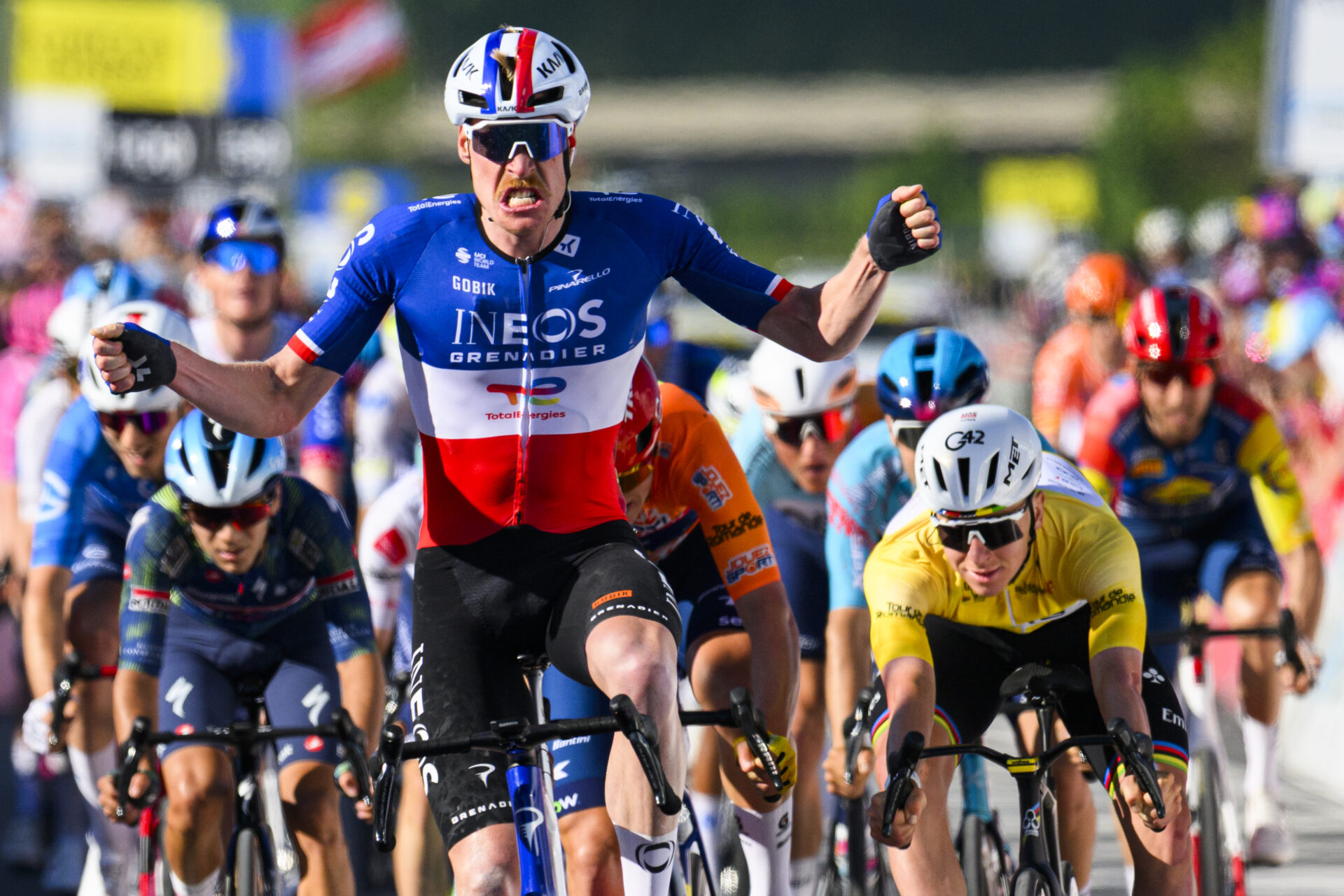 Winner Dorion Godon, left, from France of team INEOS Grenadiers raises his arms after crossing the finish line to win the third stage in front of fourth placed Tadej Pogacar, right, from Slovenia of UAE Team Emirates XRG, a 176,6 km race around Orbe at the 79th Tour de Romandie UCI World Tour Cycling race, in Orbe, Switzerland, Friday, May 1, 2026. (KEYSTONE/Jean-Christophe Bott)