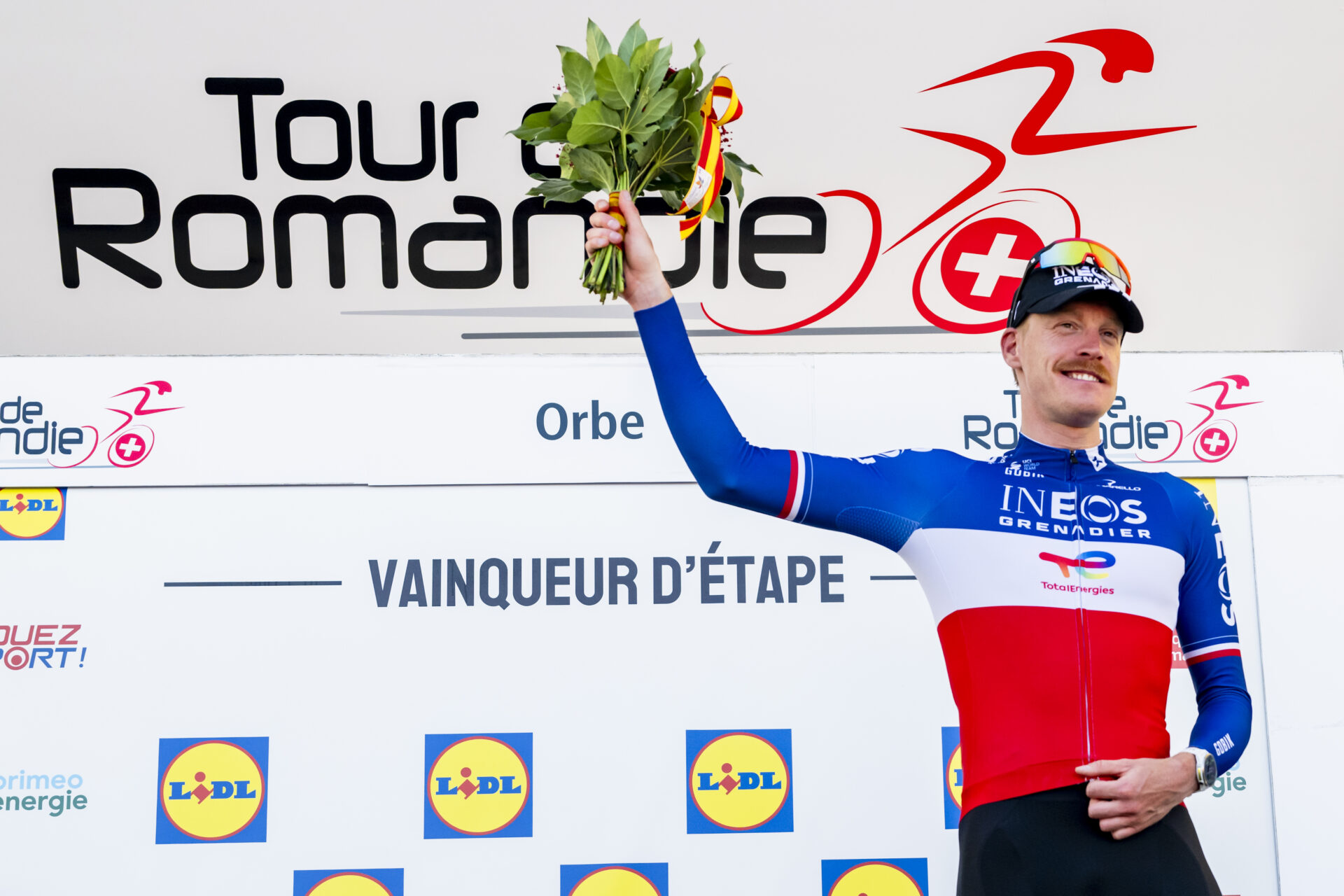 The winner of the stage Dorion Godon from France of team INEOS Grenadiers celebrates on the podium during the third stage, a 176,6 km race around Orbe at the 79th Tour de Romandie UCI World Tour Cycling race, in Orbe, Switzerland, Friday, May 1, 2026. (KEYSTONE/Jean-Christophe Bott)