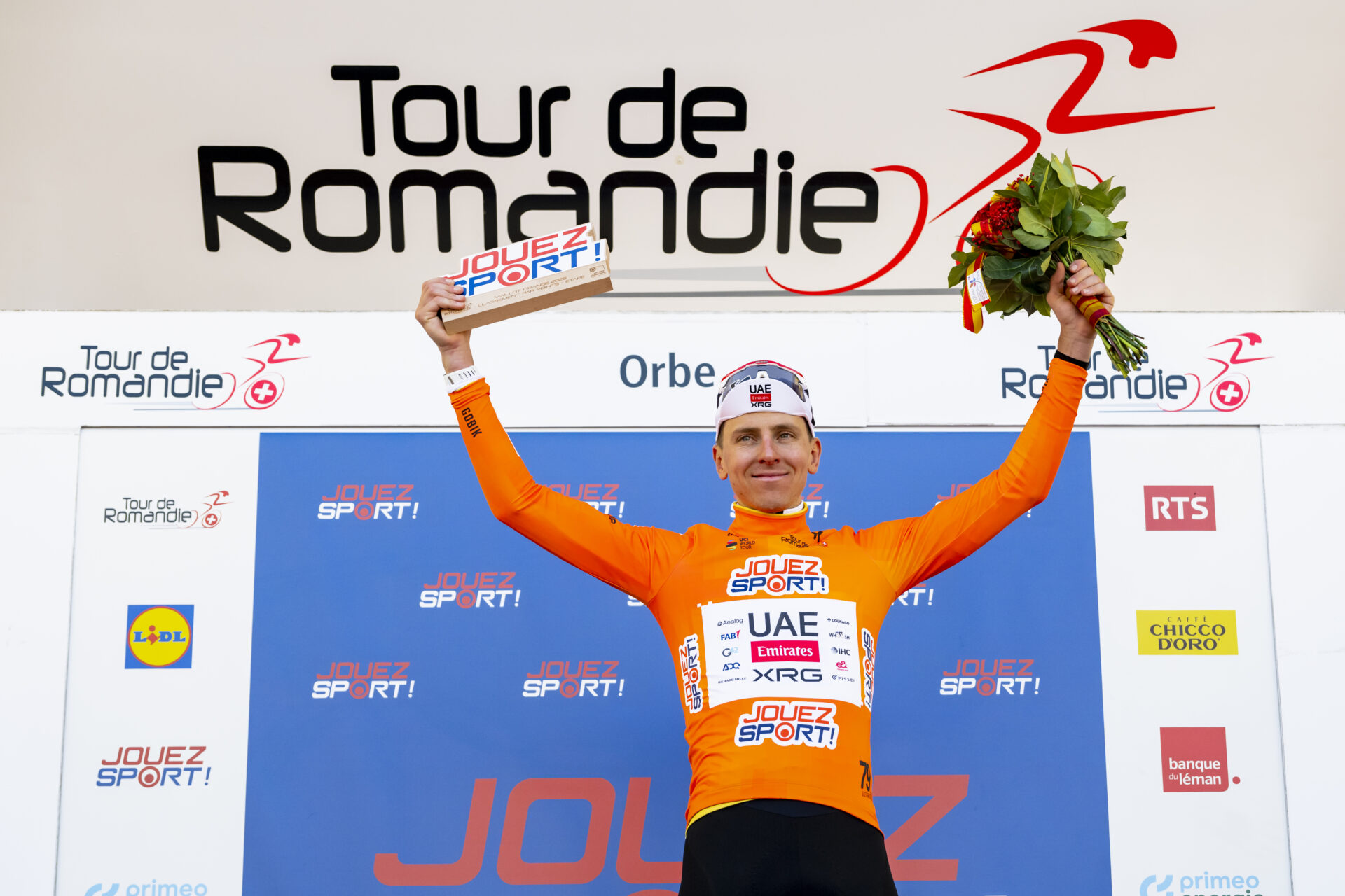 Tadej Pogacar from Slovenia of UAE Team Emirates XRG celebrates on the podium during the third stage, a 176,6 km race around Orbe at the 79th Tour de Romandie UCI World Tour Cycling race, in Orbe, Switzerland, Friday, May 1, 2026. (KEYSTONE/Jean-Christophe Bott)