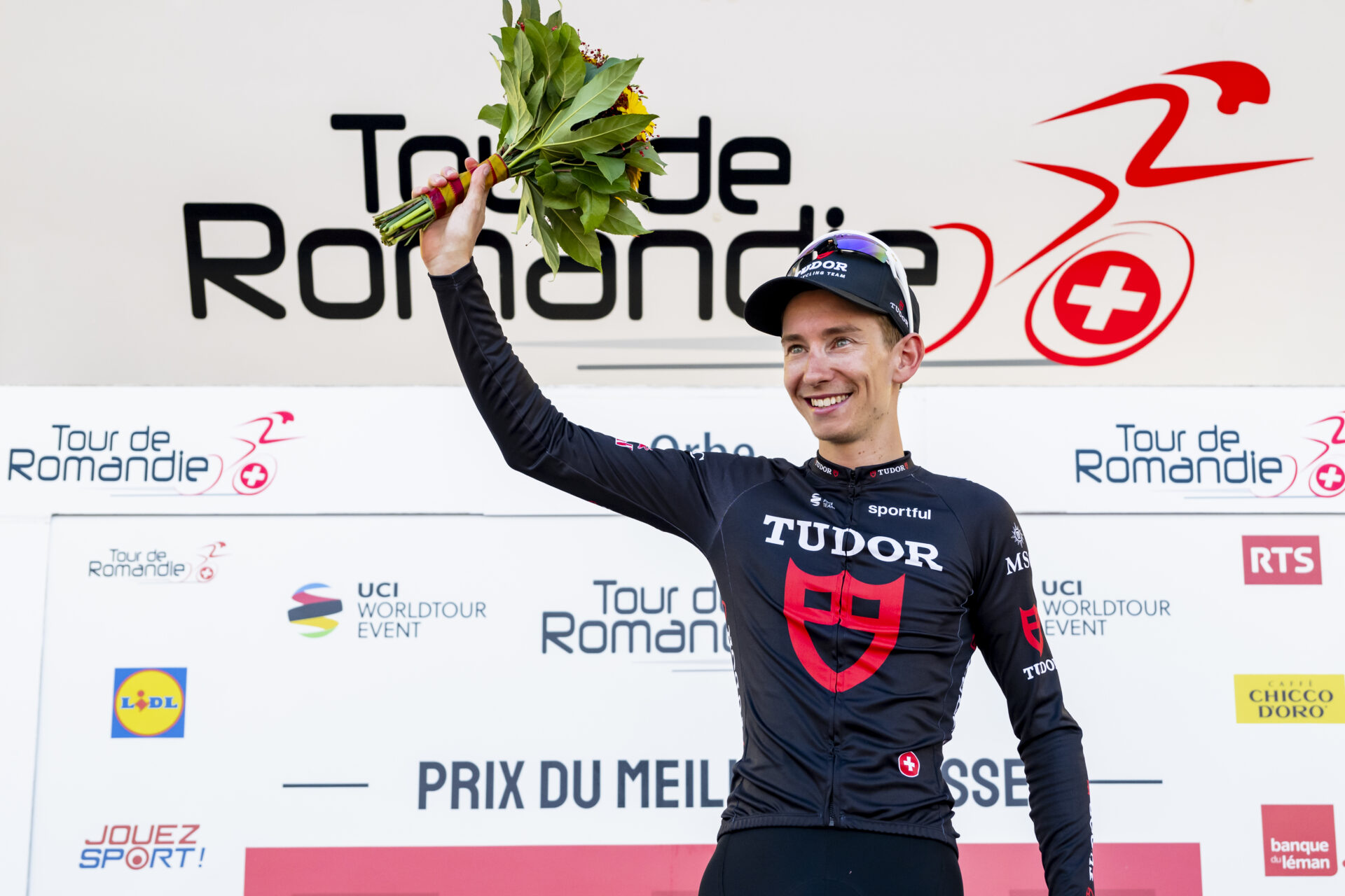 Yannis Voisard from Switzerland of Tudor Pro Cycling Team celebrates on the podium during the third stage, a 176,6 km race around Orbe at the 79th Tour de Romandie UCI World Tour Cycling race, in Orbe, Switzerland, Friday, May 1, 2026. (KEYSTONE/Jean-Christophe Bott)