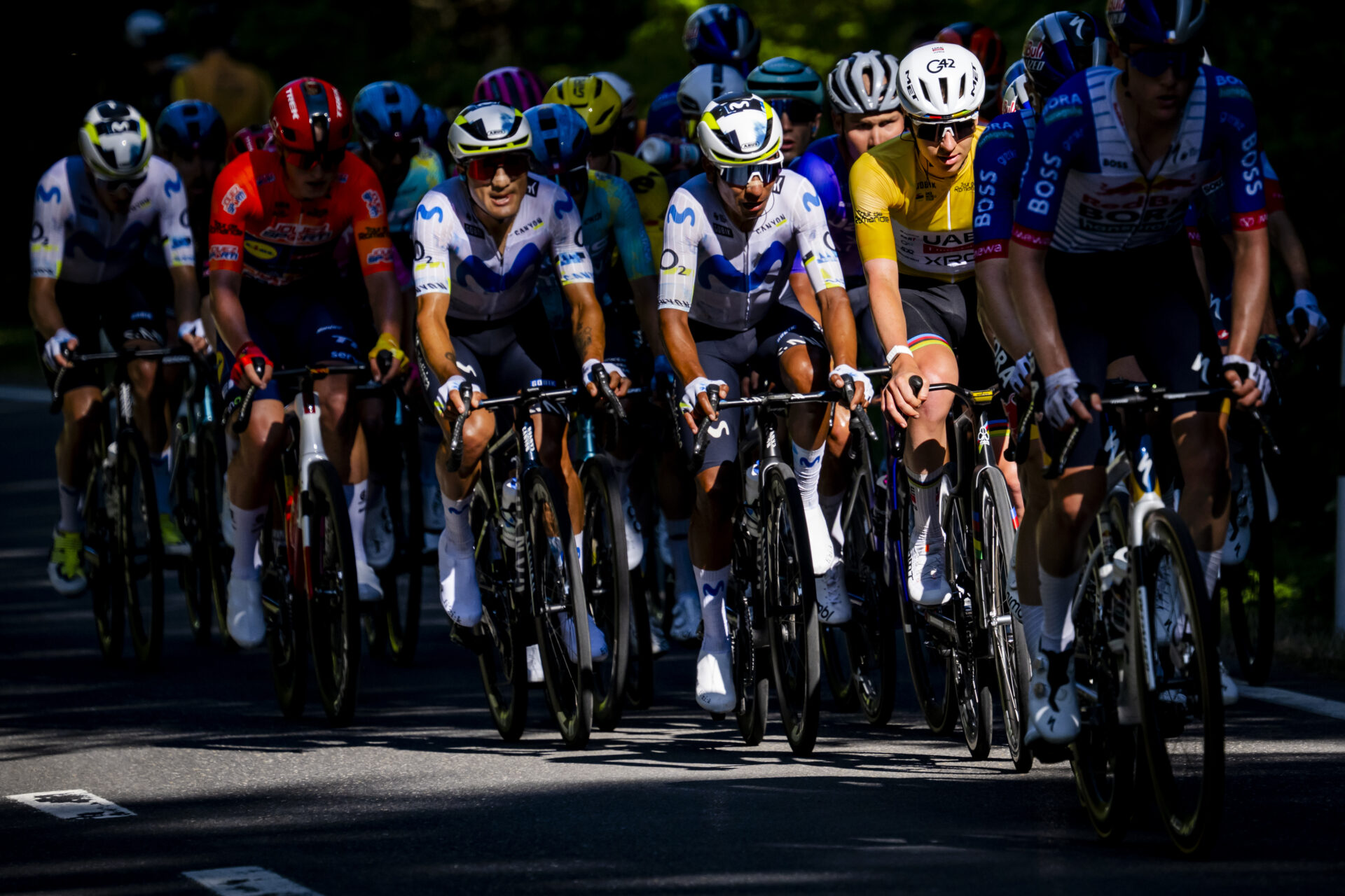 The overall leader Tadej Pogacar from Slovenia of UAE Team Emirates XRG, 2nd right, climbs inside the pack of riders the Mollendruz pass during the third stage, a 176,6 km race around Orbe at the 79th Tour de Romandie UCI World Tour Cycling race, in Mollendruz, Switzerland, Friday, May 1, 2026. (KEYSTONE/Jean-Christophe Bott)