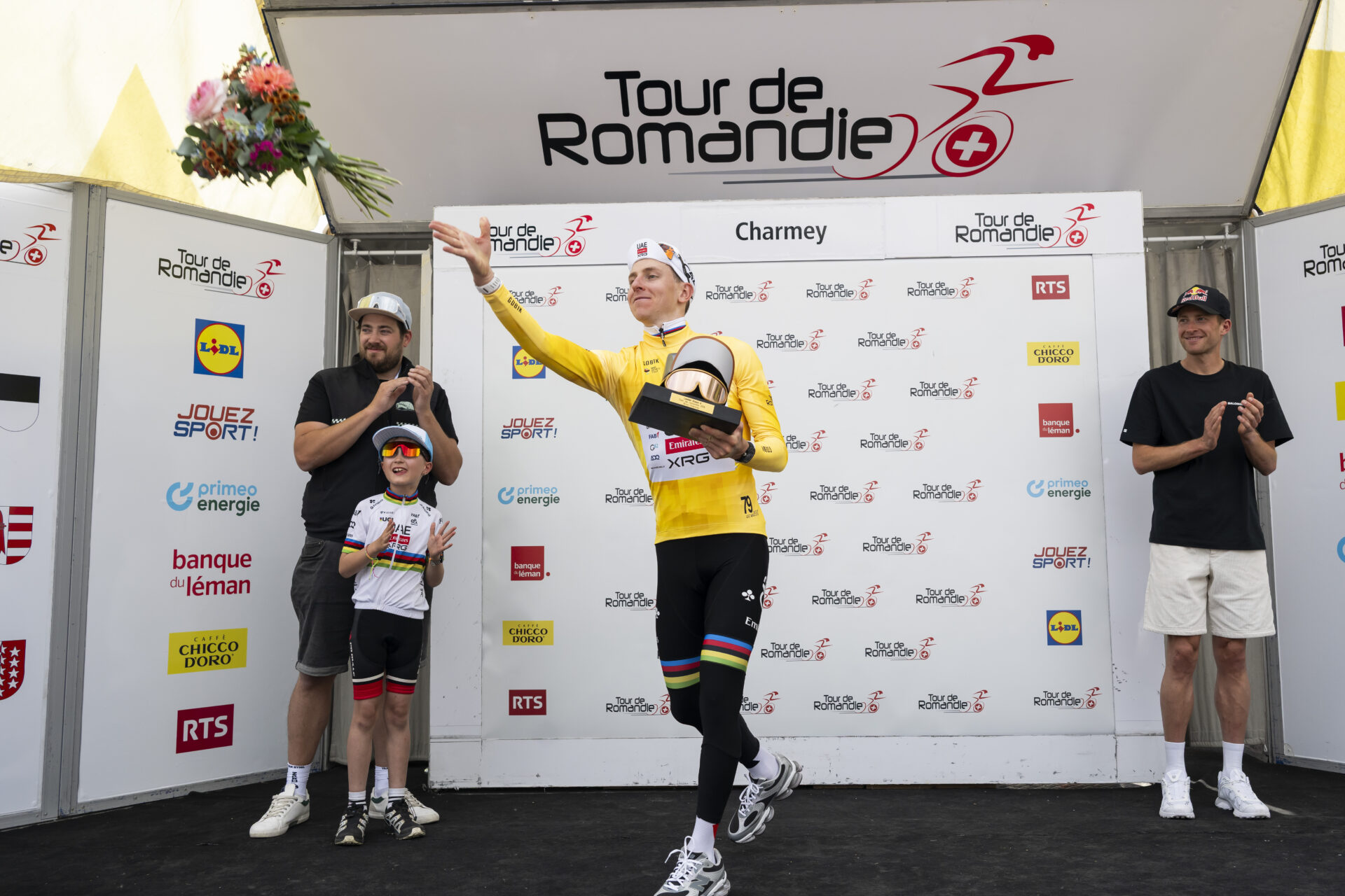 KEYPIX - The overall leader Tadej Pogacar from Slovenia of UAE Team Emirates XRG celebrates on the podium with the yellow jersey after during the fourth stage, a 149,6 km race between Broc and Charmey at the 79th Tour de Romandie UCI World Tour Cycling race, in Charmey, Switzerland, Saturday, May 2, 2026. (KEYSTONE/Jean-Christophe Bott)
