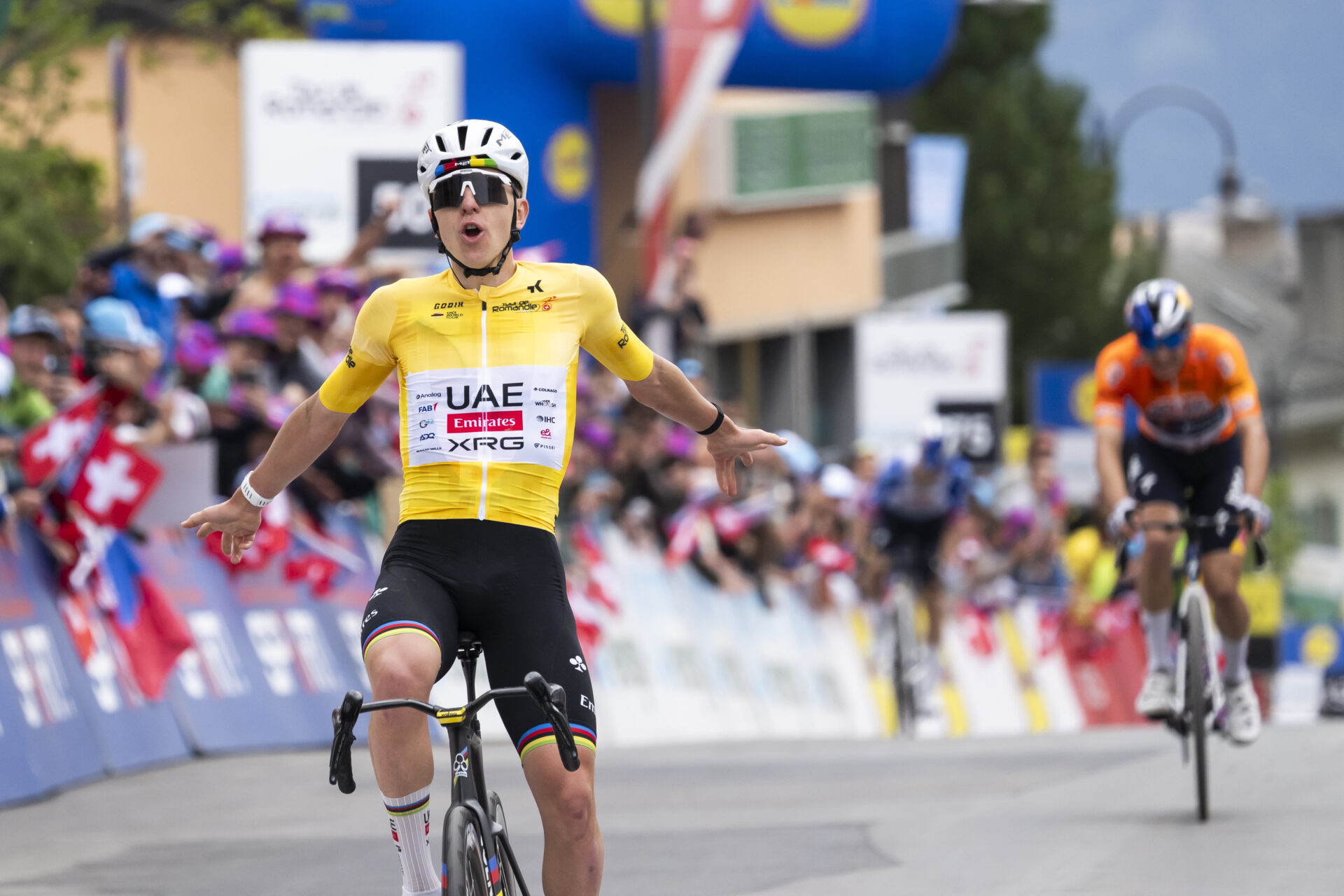 Tadej Pogacar from Slovenia of UAE Team Emirates XRG raises his arms after crossing the finish line to win during the fifth and last stage, a 178,2 km race between Lucens and Leysin at the 79th Tour de Romandie UCI World Tour Cycling race, in Leysin, Switzerland, Sunday, May 3, 2026. (KEYSTONE/Jean-Christophe Bott)