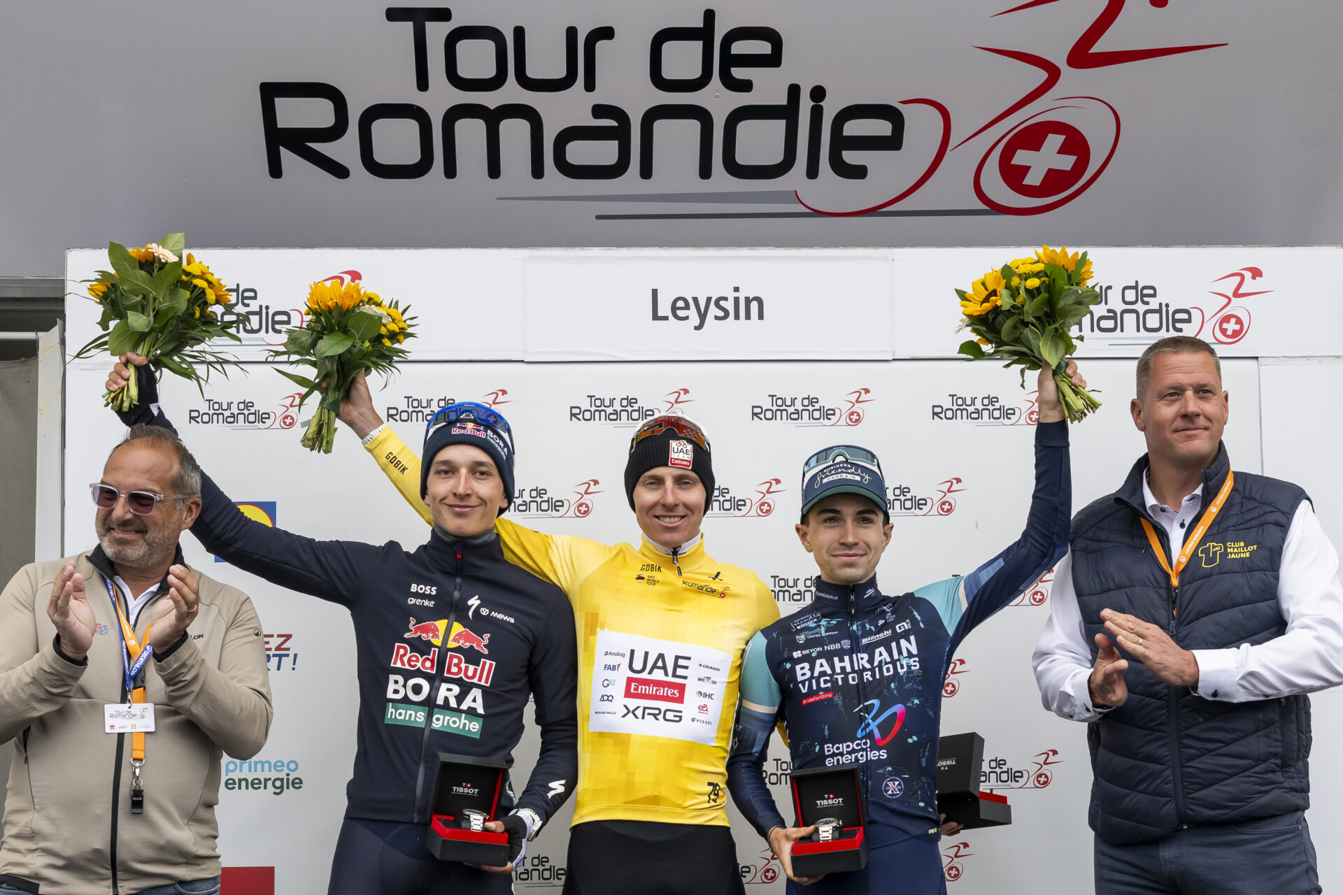 Second placed Florian Lipowitz from Germany of team Red Bull BORA hansgrohe, left, the winner of the Tour de Romandie 2026 Tadej Pogacar from Slovenia of UAE Team Emirates XRG, center, third placed Lenny Martinez from France of team Bahrain Victorious, right, celebrate on the podium during the fifth and last stage, a 178,2 km race between Lucens and Leysin at the 79th Tour de Romandie UCI World Tour Cycling race, in Leysin, Switzerland, Sunday, May 3, 2026. (KEYSTONE/Jean-Christophe Bott)