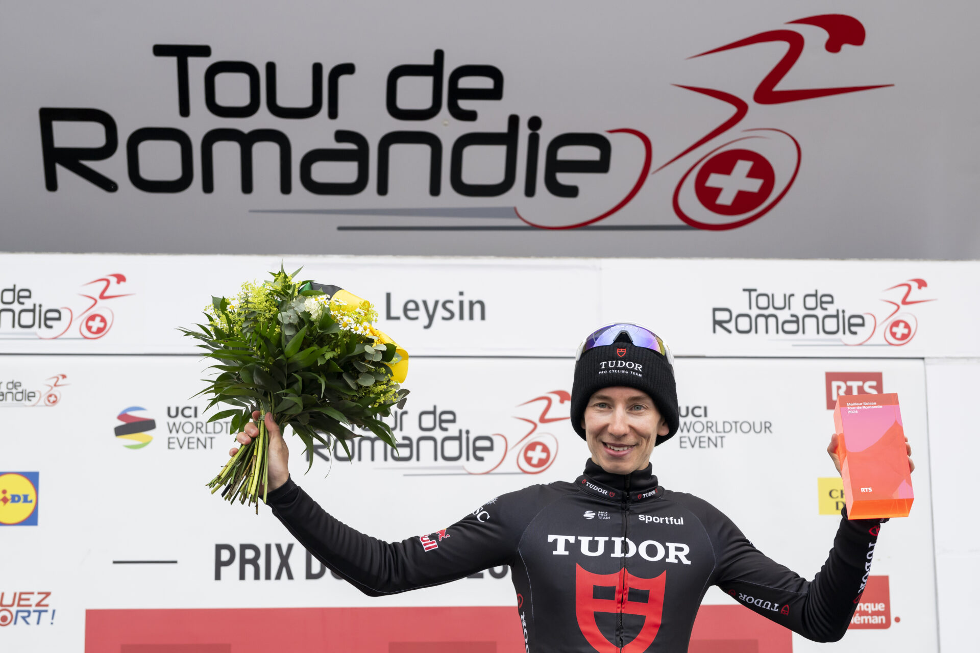 Yannis Voisard from Switzerland of Tudor Pro Cycling Team celebrates on the podium during the fifth and last stage, a 178,2 km race between Lucens and Leysin at the 79th Tour de Romandie UCI World Tour Cycling race, in Leysin, Switzerland, Sunday, May 3, 2026. (KEYSTONE/Jean-Christophe Bott)